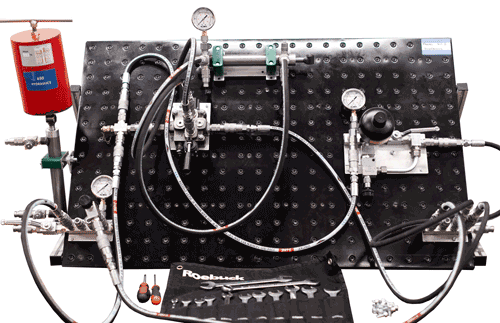 Candidates build hydraulic circuits on the modular boards used on the hydraulic training courses by connecting together the necessary components