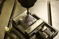Candidates make a v-block on the engineering fitting skills course