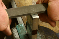 Candidates make a v-block on the engineering fitting skills course